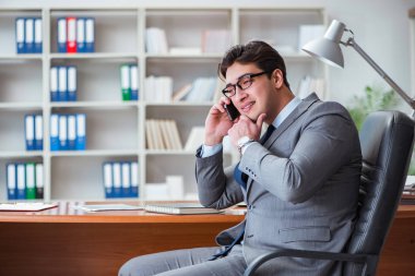 Ofiste çalışan genç bir işadamı.