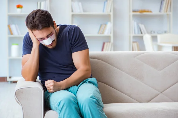 Young man recovering healing at home after plastic surgery nose — Stock Photo, Image