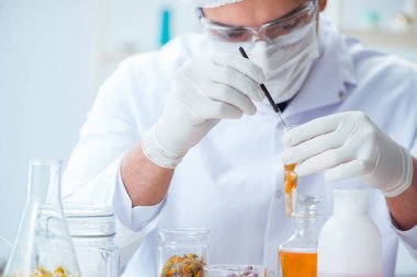 Laboratuvarda parfüm karıştıran bir kimyager.