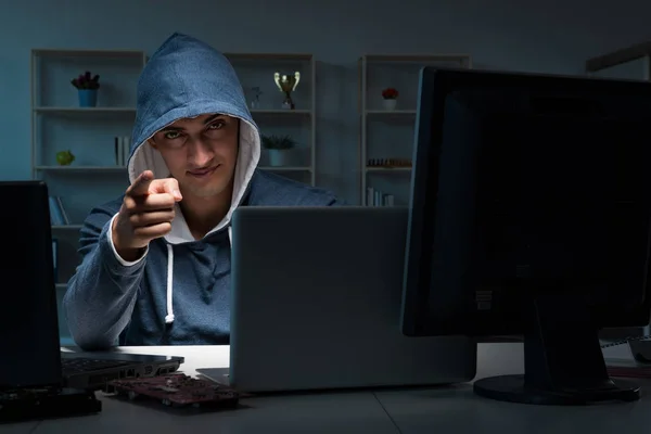 Hacker hacking computer at night