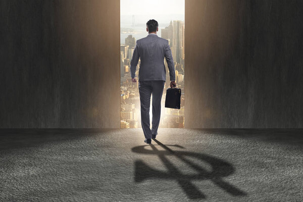 Businessman casting dollar shape shadow in business concept