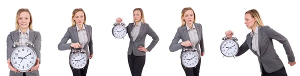 Mujer de negocios en traje gris con reloj despertador aislado en blanco — Foto de Stock