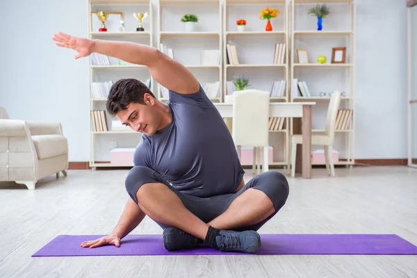 Giovane uomo che esercita a casa in sport e stile di vita sano con — Foto Stock