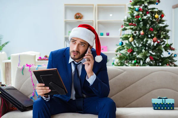 Businessman working at home during christmas