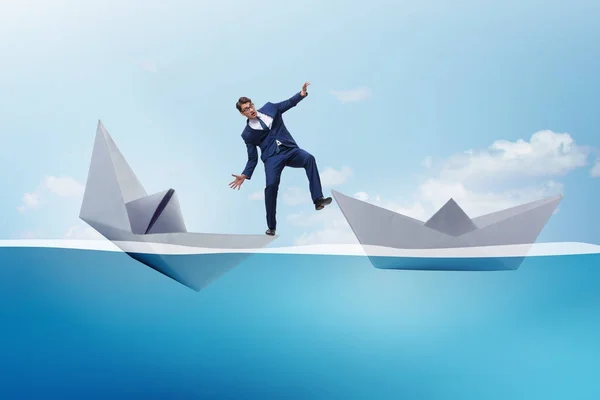Businessman escaping sunken paper boat ship — Stock Photo, Image