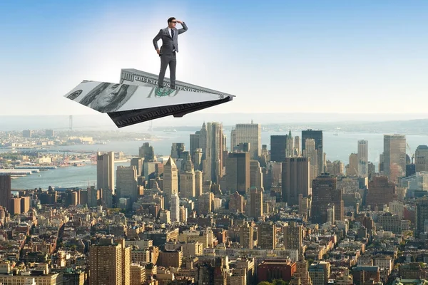 Businessman flying on paper plane in business concept