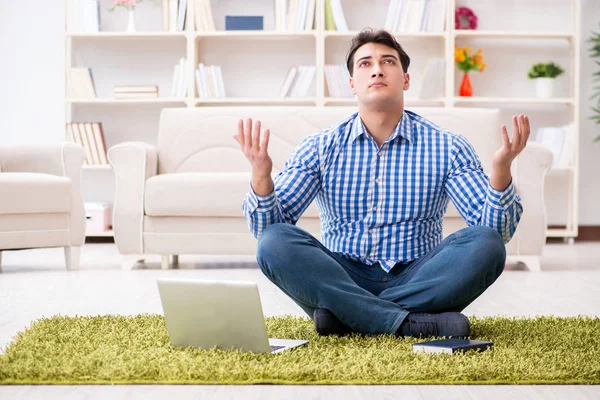 Young handsome man sitting on floor at home — Stock Photo, Image