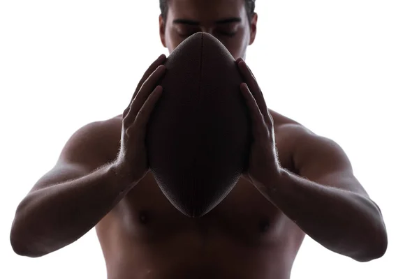 Abgerissener junger Mann mit American Football auf Weiß — Stockfoto