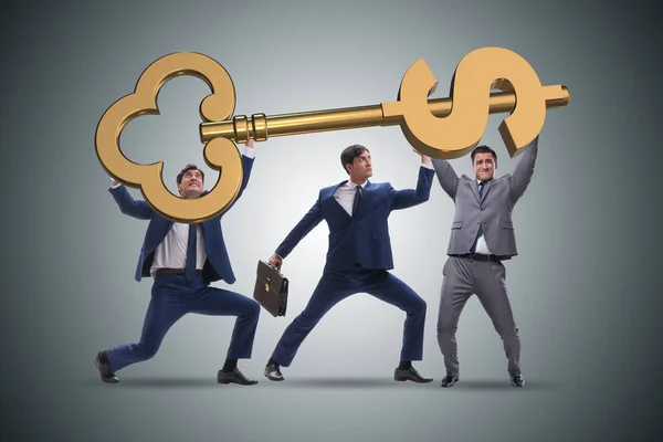 Businessmen holding giant key in finance concept — Stock Photo, Image