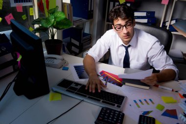 İş adamı ofiste geç saatlere kadar çalışıyor.