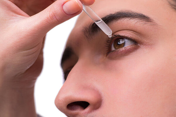 Young man in eye care medical concept