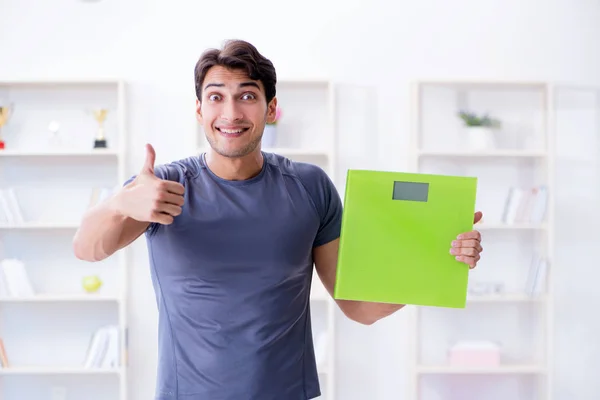 Man with scales in sports and health concept — Stock Photo, Image