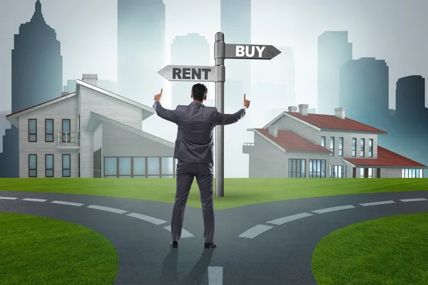 Businessman at crossroads betweem buying and renting — Stock Photo, Image