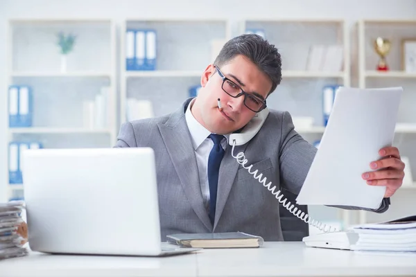 Businessman smoking in office at work — Stock Photo, Image