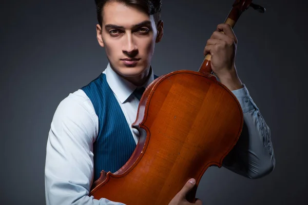 Jeune homme jouant du violoncelle dans la chambre noire — Photo