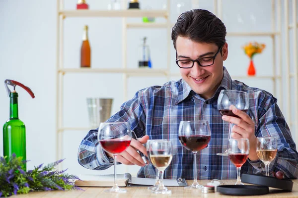 Professional sommelier tasting red wine