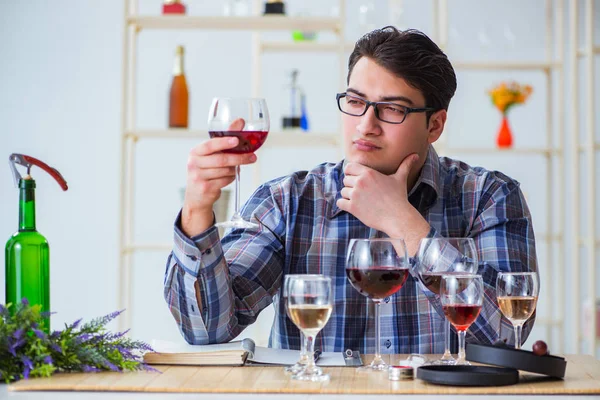 Professional sommelier tasting red wine