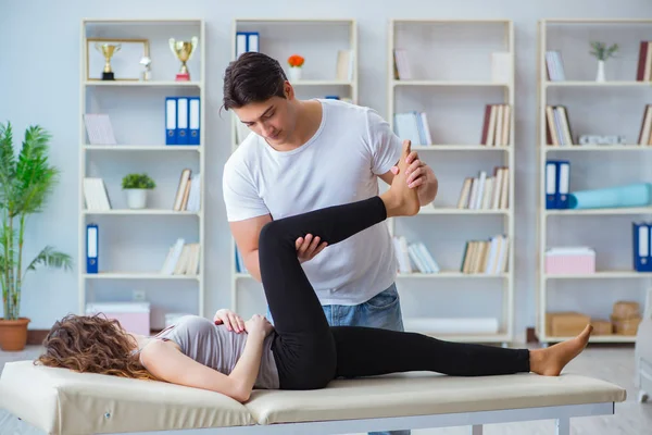 Young doctor chiropractor massaging female patient woman — Stock Photo, Image