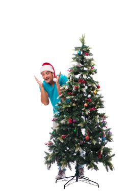 Genç adam beyaz üzerine izole edilmiş noel ağacını süslüyor.