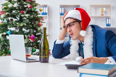 İş adamı Noel tatilini ofiste kutluyor.