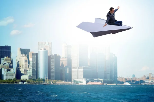 Businessman flying on paper plane in business concept — Stock Photo, Image