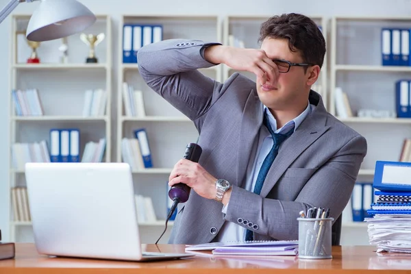 Businessman sweating excessively smelling bad in office at workp