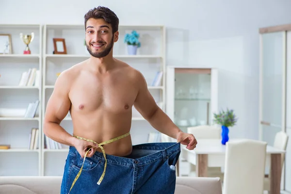 Man in oversized pants in weight loss concept — Stock Photo, Image