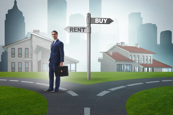 Businessman at crossroads betweem buying and renting — Stock Photo, Image