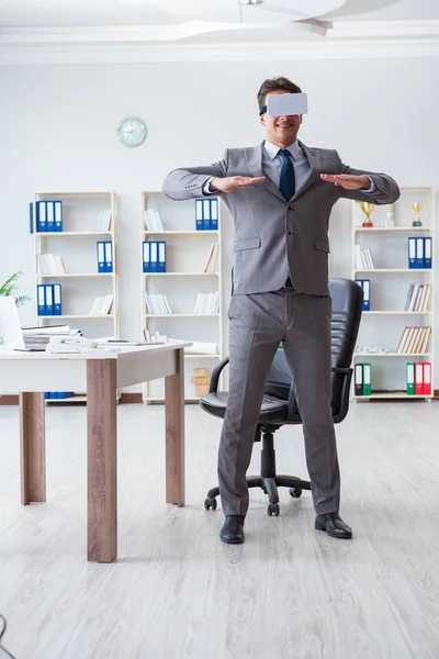 Businessman exercising in office wearing VR glasses