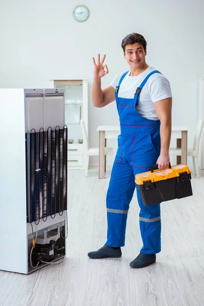 Repairman contractor repairing fridge in DIY concept