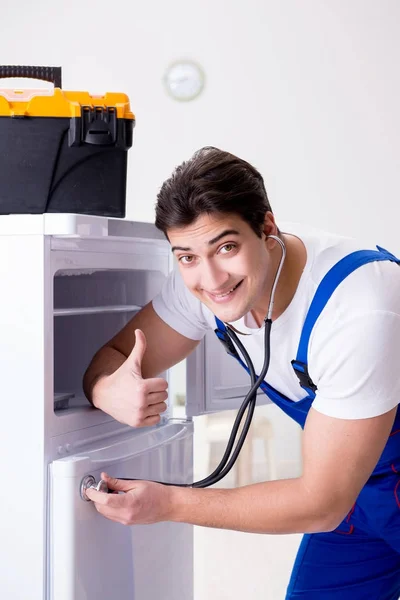 Repairman contractor repairing fridge in DIY concept