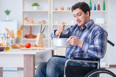 Engelli adam mutfakta çorba hazırlıyor.