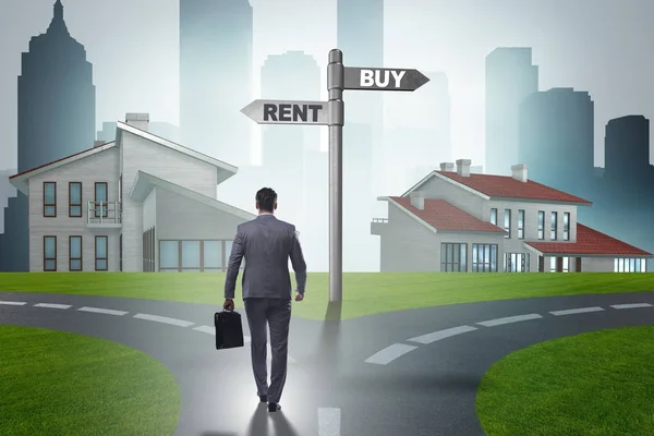 Businessman at crossroads betweem buying and renting — Stock Photo, Image