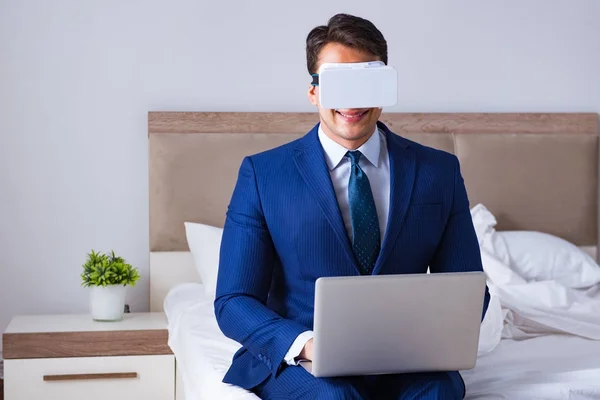 Επιχειρηματίας φορώντας μια εικονική πραγματικότητα ακουστικά στην κρεβατοκάμαρα — Φωτογραφία Αρχείου