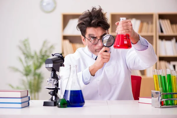 Mad crazy scientist doctor doing experiments in a laboratory — Stock Photo, Image