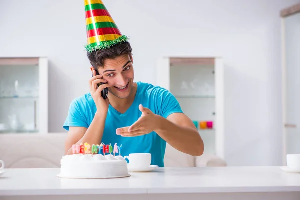 Young man celebrating birthday alone at home