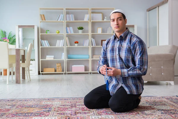 Young muslim man praying at home — Stock Photo, Image