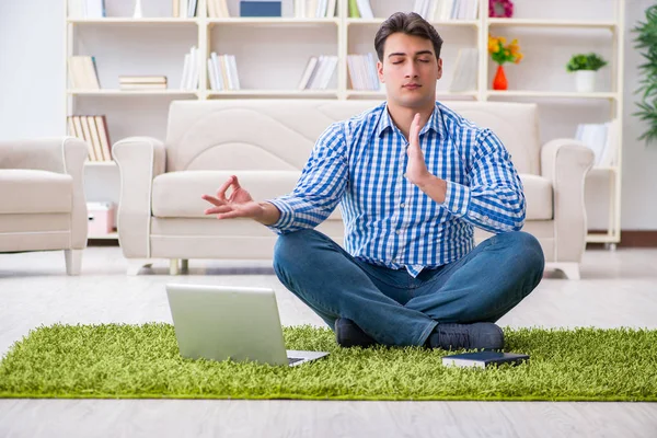 Young handsome man sitting on floor at home — Stock Photo, Image