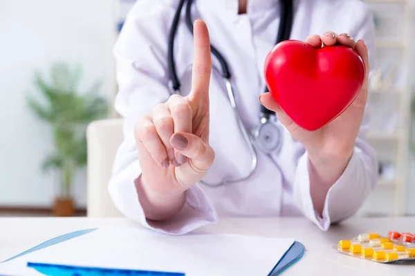 Medico cardiologo con cuore rosso in ospedale — Foto Stock