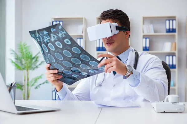 Young doctor looking at MRI scan through VR glasses — Stock Photo, Image