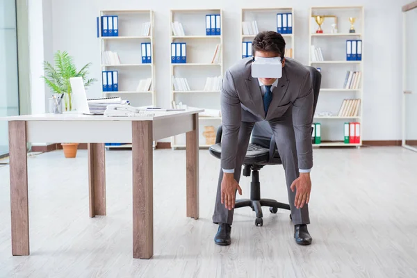 Businessman exercising in office wearing VR glasses — Stock Photo, Image