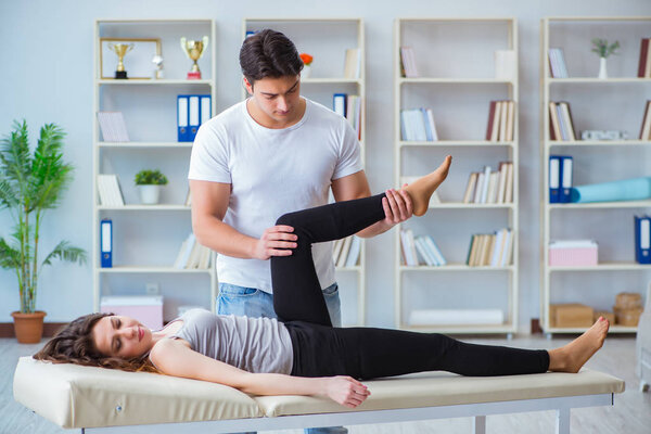 Young doctor chiropractor massaging female patient woman