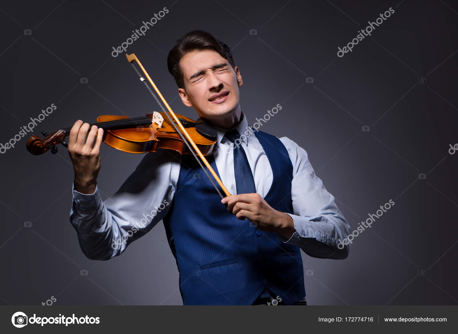 Young Man Playing Violin In Dark Room Stock Photo C Elnur