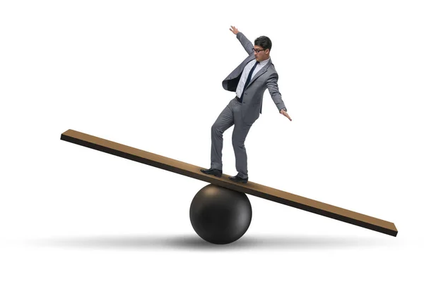 Businessman balancing on seesaw in uncertainty concept — Stock Photo, Image