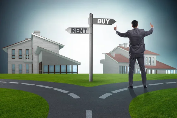 Businessman at crossroads betweem buying and renting — Stock Photo, Image