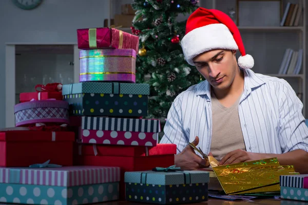 Man with many christmas gifts in boxes — Stock Photo, Image