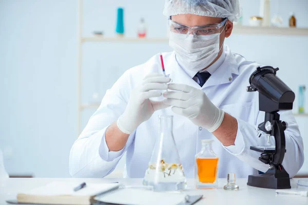 Chemist mixing perfumes in the lab