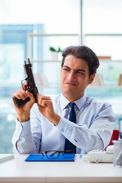 Angry businessman with gun thinking of committing suicide — Stock Photo, Image