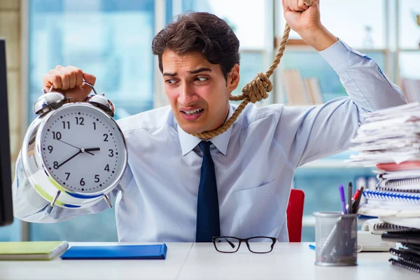 Unhappy businessman thinking of hanging himself in the office