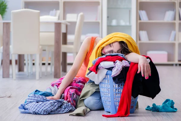 Stressed woman doing laundry at home — Stock Photo, Image